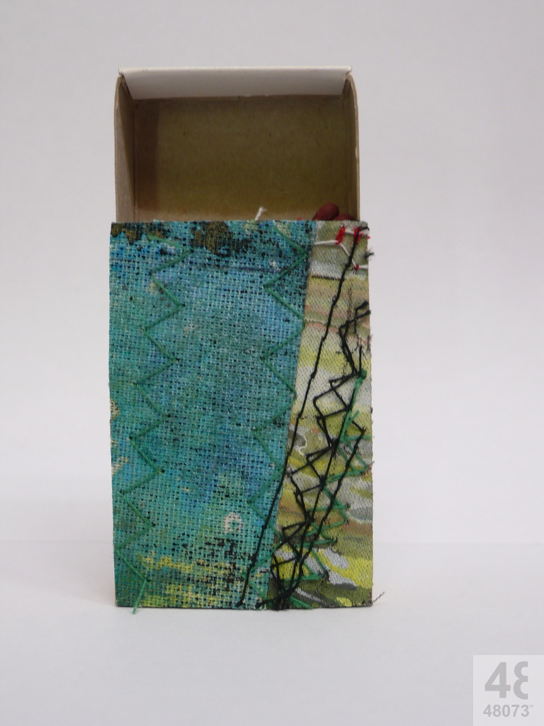 Small abstract painting on matchbox.