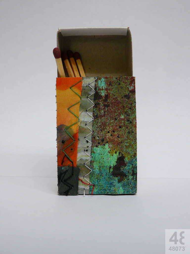 Small abstract painting on matchbox.